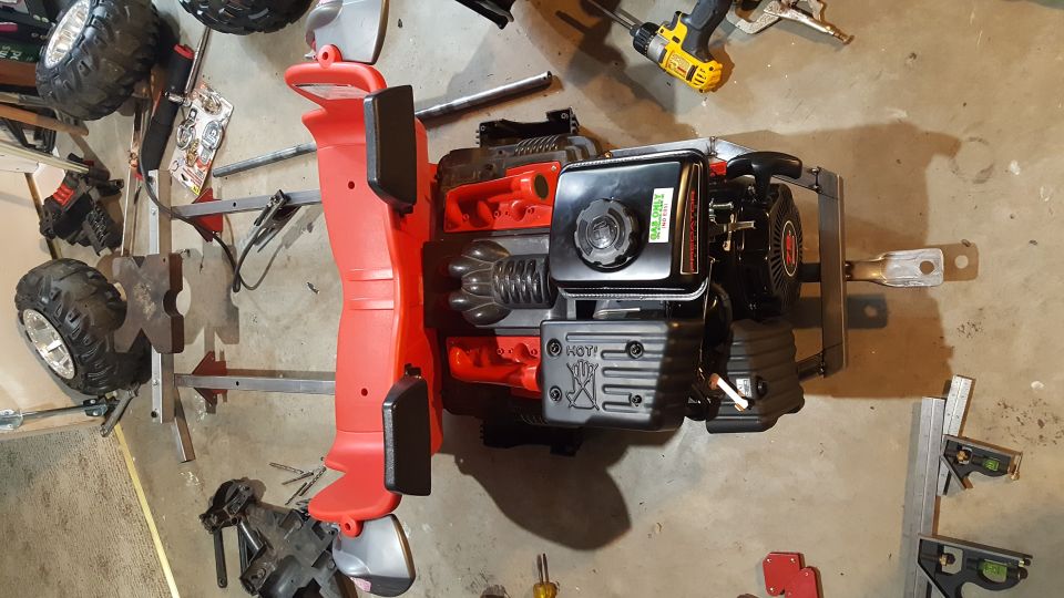 Red plastic body with small engine and large tires