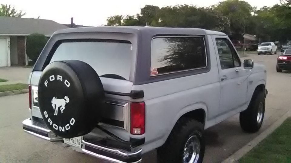 Gray 1986 Ford Bronco, rear quarter view, with spare tire cover