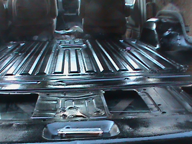 Black-coated ribbed truck cab or bed floor pan interior with seat mounts