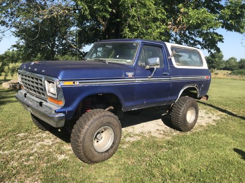 1979 Ford Bronco - This lifted 1978 Ford Bronco has oversized tires and is parked outdoors.