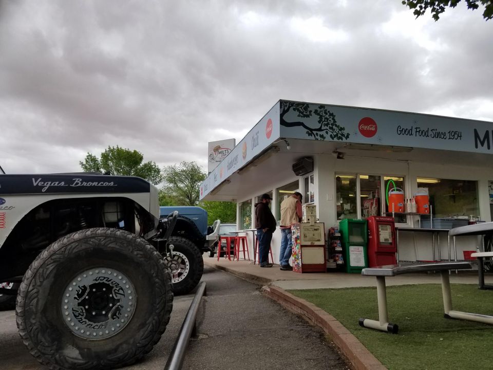 White-and-blue Ford Bronco parked at a retro 1950s diner