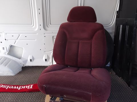 1999 Ford E250 - A maroon fabric van seat with a headrest is positioned inside a white van. A red Budweiser mat is visible on the floor in front of the seat.