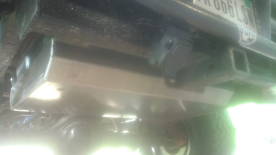 Underbody view of vehicle with trailer hitch and skid plate