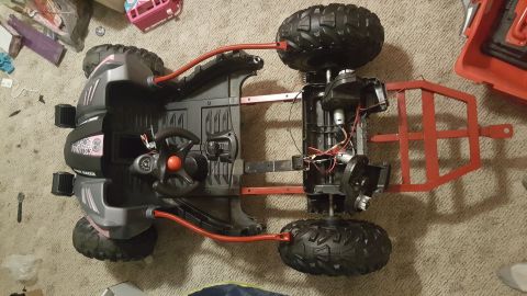 2007 Subaru Impreza - Chassis of a toy ATV, showing the steering wheel, motors, and suspension components.