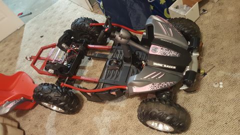 2007 Subaru Impreza - This toy dune racer has a red frame and a grey body with pink accents and text.