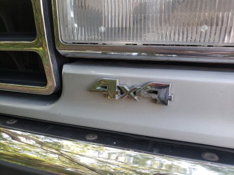 1989 Ford Bronco - Close-up of the 4x4 emblem on a 1989 Ford Bronco.
