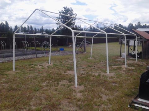 1995 Ford Bronco - A white pipe frame structure stands in a grassy yard, with trees and houses visible in the distance.