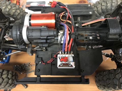 1989 Ford Bronco - Close-up of an RC car chassis showing the electronic speed controller, motor, and suspension components.
