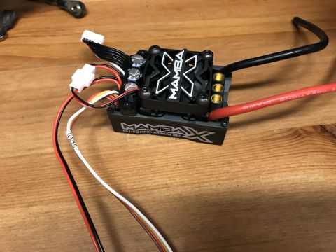 1989 Ford Bronco - An electronic speed controller with a fan and multiple wires is shown on a wooden surface.