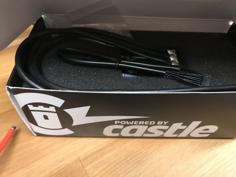 1989 Ford Bronco - Box containing black cables and connectors with 'POWERED BY castle' branding.