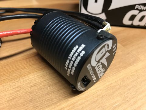1989 Ford Bronco - Close-up of a black Castle Creations sensored RC motor, showing its ribbed casing and visible wiring.