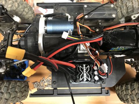 1989 Ford Bronco - The intricate wiring and components of a remote-controlled vehicle's chassis are visible.