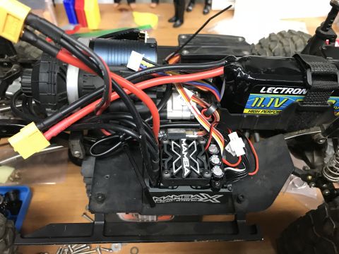 1989 Ford Bronco - Close-up view of the internal electronics of a remote-controlled car, including battery and motor.