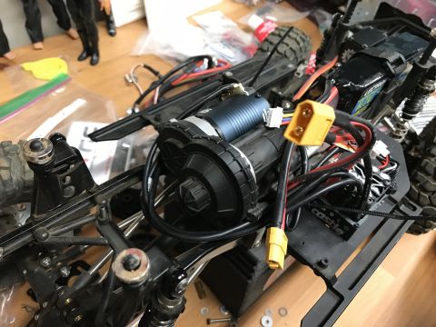 1989 Ford Bronco - Close-up of an RC car chassis, showing the motor, battery, and electronic speed controller labeled 'Castle'.