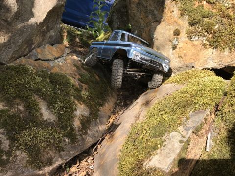 1989 Ford Bronco - Toy truck model is shown off-roading on a simulated rocky landscape.