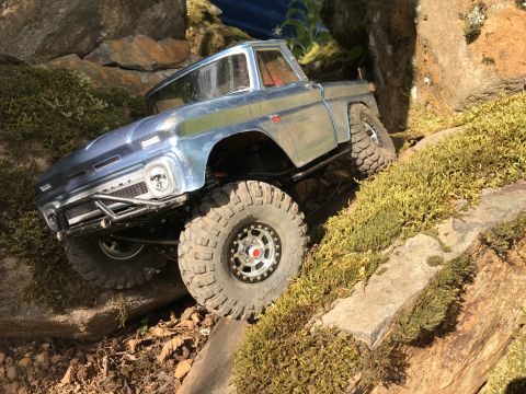 1989 Ford Bronco - A remote-controlled truck navigates a rocky, moss-covered terrain.
