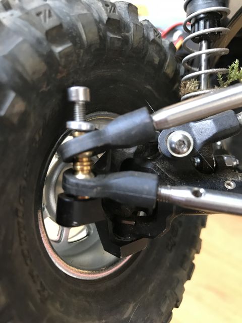 1989 Ford Bronco - Detail of a remote control car's suspension system and off-road tire.