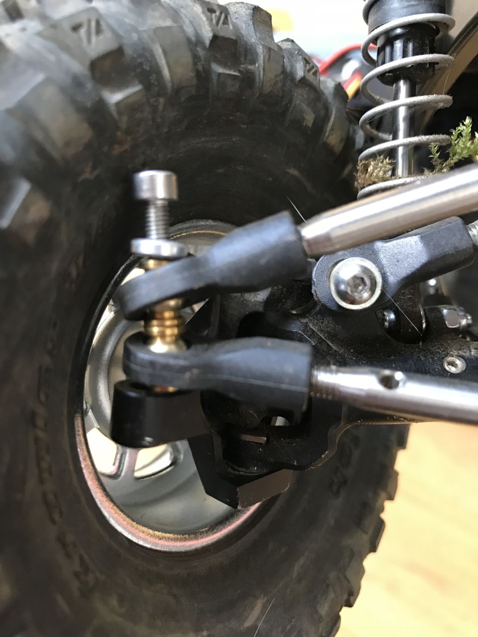 Close-up of RC car suspension linkage and tire