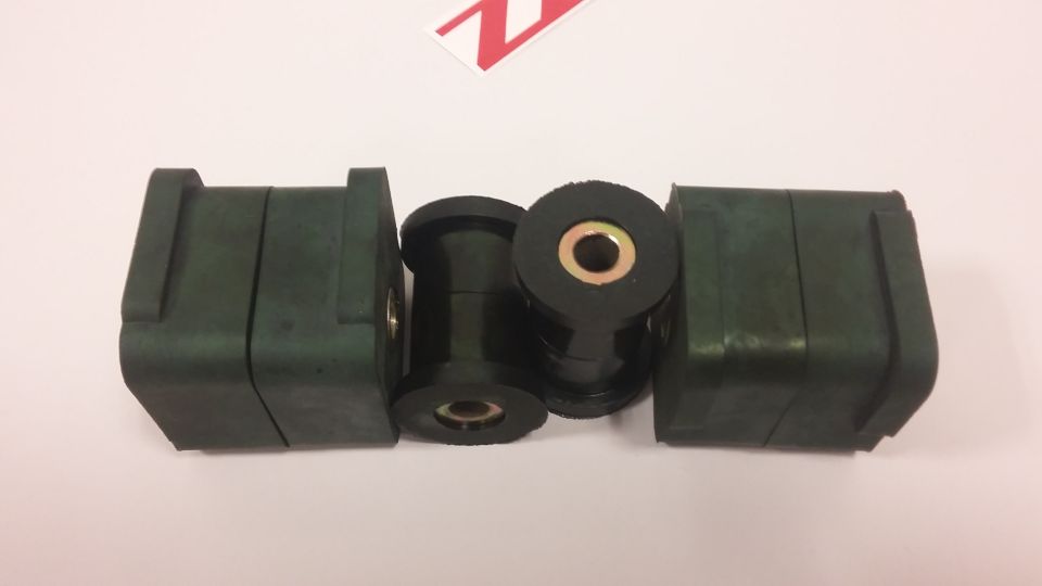 Four black suspension bushings with metal inserts
