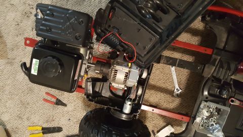 2007 Subaru Impreza - A go-kart chassis is disassembled on a carpeted floor, showing its engine and electrical components.