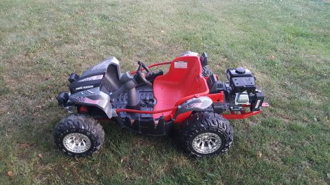 2007 Subaru Impreza - This red and grey dune buggy features large off-road tires and a visible engine, suggesting it is designed for rough terrain.