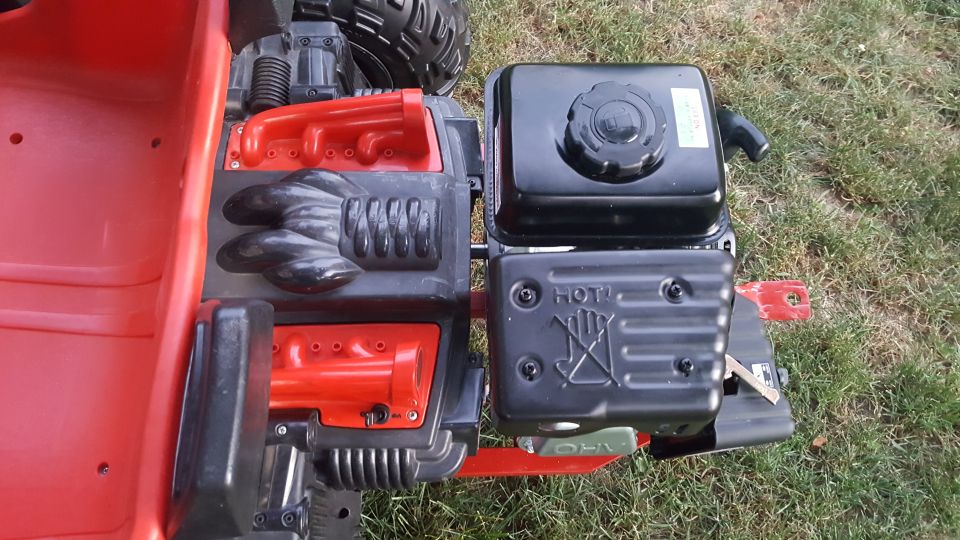 Red plastic body with a small black gas engine mounted on it