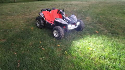 2007 Subaru Impreza - This red and black dune buggy is parked on a grassy area with its headlights illuminated.