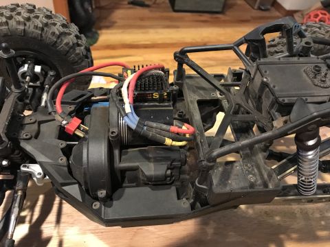 1989 Ford Bronco - The internal components of a remote-controlled car are visible, including the motor and suspension system.