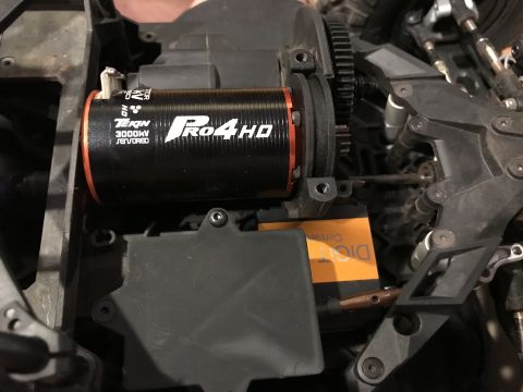 1989 Ford Bronco - Close-up view of a Tekin Pro4HD 3000KV brushless motor and associated gears within an RC vehicle.