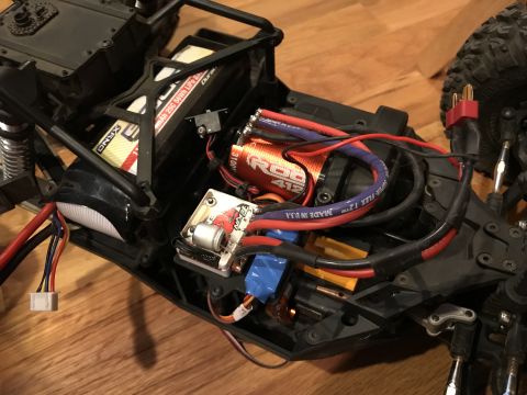 1989 Ford Bronco - Close-up view of the internal components of a remote-controlled car, including the motor and battery pack.