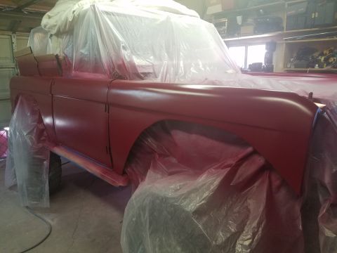1968 Ford Bronco - This vehicle is covered in plastic and tarps, likely in a garage, as it undergoes a paint job.