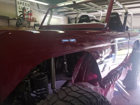 1968 Ford Bronco - A red 1968 Ford Bronco is shown with its interior visible, a roll cage and Bride racing seats.