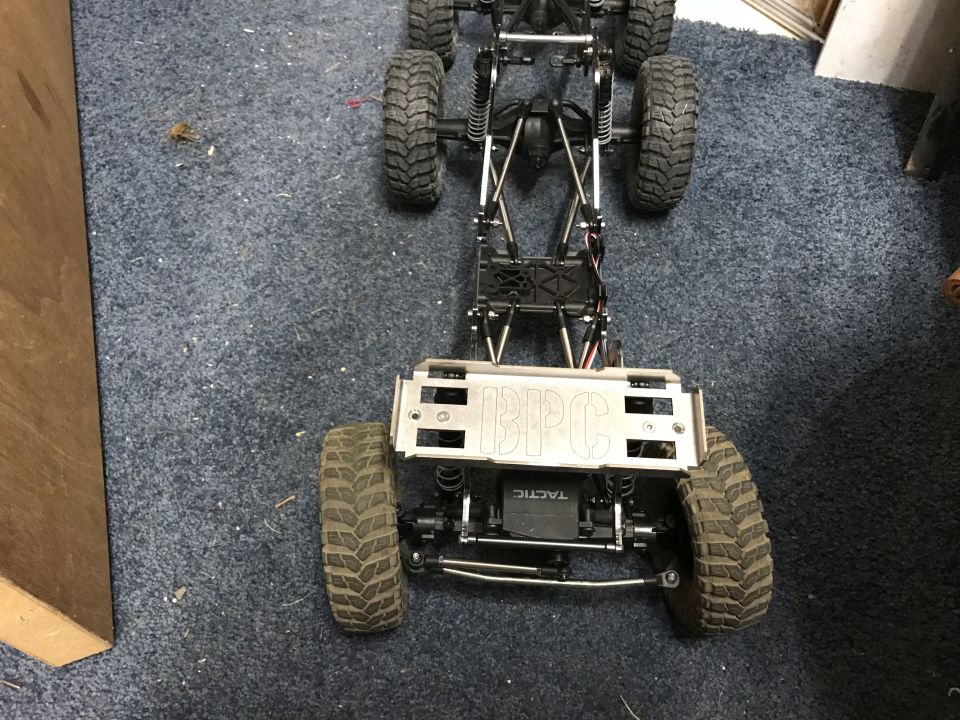 RC car chassis with BPC etched on a metal plate, viewed from the front
