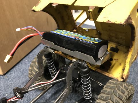 1989 Ford Bronco - The battery pack on this RC car chassis has visible text and wiring leading to the electronics.
