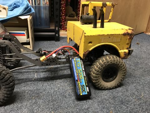 1989 Ford Bronco - RC rock crawler chassis with a yellow Tonka toy truck body and a LiPo battery.