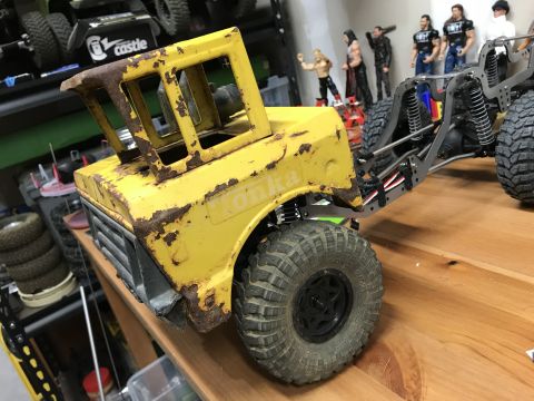 1989 Ford Bronco - Rusted yellow Tonka toy truck body with visible chassis and suspension components.