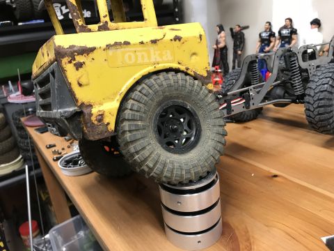 1989 Ford Bronco - A weathered yellow Tonka truck body is shown with a separate chassis and figures in the background.