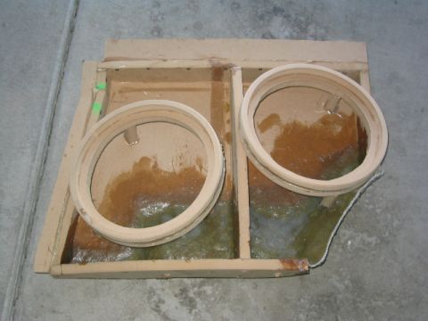 1989 Ford Bronco - A custom-built subwoofer enclosure with wooden rings and fiberglass resin is shown.