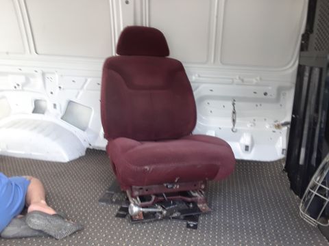 1999 Ford E250 - The interior of a 1999 Ford E250 cargo van shows a single maroon seat installed.