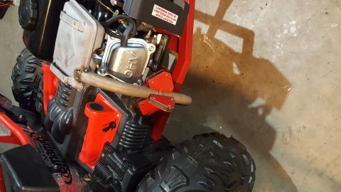 2007 Subaru Impreza - Close-up view of the engine and tires on a red ATV.