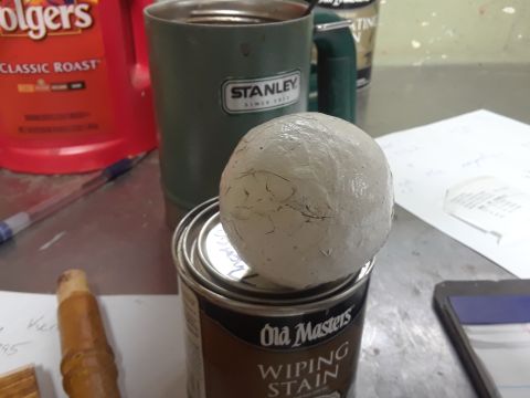 1994 Ford Bronco - A collection of items on a workbench, including a can of stain, a mug, and a container of coffee.