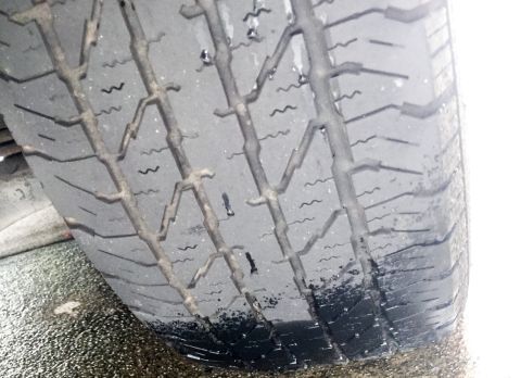 2003 Ford Explorer - The tread on this tire is significantly worn down, showing the wear bars.