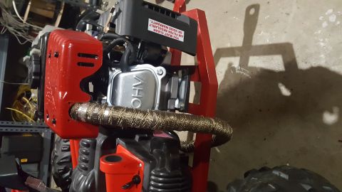 2007 Subaru Impreza - Engine detail with red casing and exhaust wrap. A warning sticker is visible on the black air filter housing.