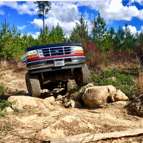 1995 Ford Bronco - This 1995 Ford Bronco tackles a challenging off-road course with large rocks.