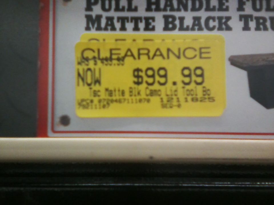 Yellow clearance sticker on a sign with sale price and item description