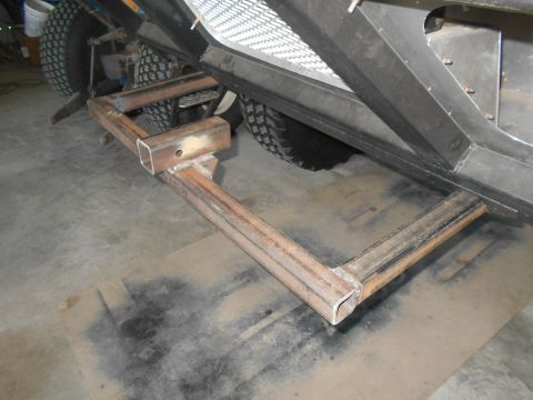 1992 Ford Bronco - A custom-fabricated steel step or hitch receiver extension is welded to the frame of a vehicle, extending outwards and downwards. The vehic…