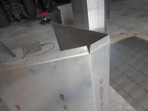 1992 Ford Bronco - Close-up of a metal corner piece with text printed on it, possibly part of a vehicle build. The metal is silver and has red lettering indic…