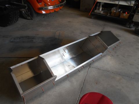 1992 Ford Bronco - A partially assembled metal fabrication is shown on a concrete floor in a workshop. The fabrication appears to be a long, rectangular box w…