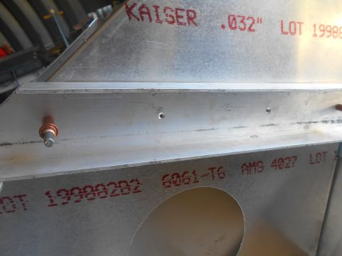 1992 Ford Bronco - Close-up view of aluminum sheet metal with red stamped markings indicating "KAISER .032" LOT 19988" and "LOT 19998282 6061-T6 AMS 4027 LOT"…