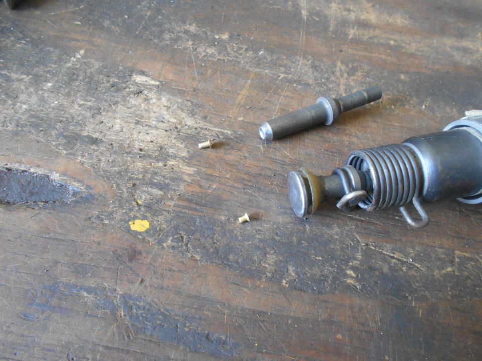 Disassembled tool parts on a wooden surface